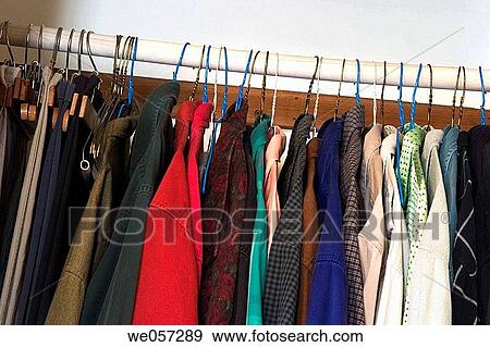 Man's shirts and pants hanging in a bedroom closet View Large Photo Image Stock Photo - Man's shirts and pants hanging in a bedroom closet. Fotosearch