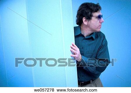 Middle_age man, wearing sunglasses, standing behind a column in a factory View Large Photo Image Stock Photo - Middle_age man, wearing sunglasses, standing behind a column in a factory. Fotosearch