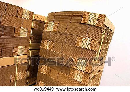 Stock Photo - New flat cardboard boxes bundled together on wooden pallers. Fotosearch