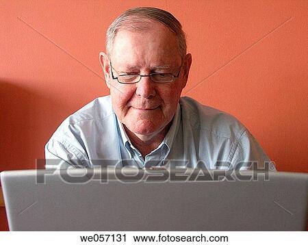 Stock Image - Senior using laptop. Fotosearch