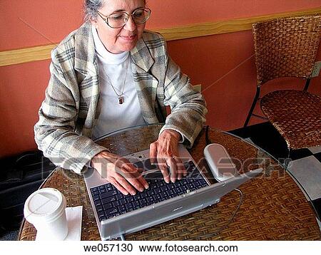 Senior using WIFI in coffee shop View Large Photo Image Stock Image - Senior using WIFI in coffee shop. Fotosearch