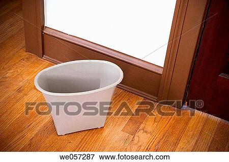 Small wastebasket on a hardwood bedroom floor View Large Photo Image Stock Photo - Small wastebasket on a hardwood bedroom floor. Fotosearch
