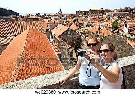 Two women taking their photo. Dubrovnik, Croatia View Large Photo Image Stock Image - Two women taking their photo. Dubrovnik, Croatia. Fotosearch