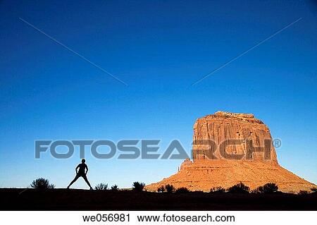 Usa. Arizona/Utha. Monument Valley, Navajo Tribal Park. Woman stretching View Large Photo Image Stock Image - Usa. Arizona/Utha. Monument Valley, Navajo Tribal Park. Woman stretching. Fotosearch