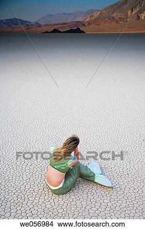 Usa. California. Death Valley National Park. Racetrack point. Woman with Mermaid costume View Large Photo Image Picture - Usa. California. Death Valley National Park. Racetrack point. Woman with Mermaid costume. Fotosearch