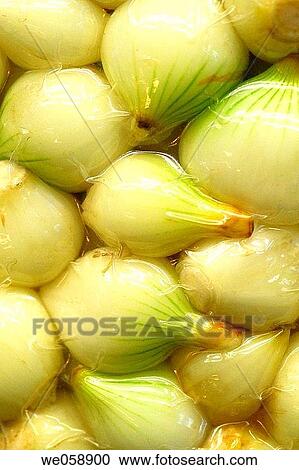 Stock Image - Vacuum packed onions at La Boqueria market, Barcelona. Catalonia, Spain. Fotosearch