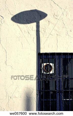 Window in old house with light post shadow on wall. Sant Salvador. El Vendrell. Baix Pened? s. Tarragona province. Catalonia. Spain. View Large Photo Image Stock Image - Window in old house with light post shadow on wall. Sant Salvador. El Vendrell. Baix Pened? s. Tarragona province. Catalonia. Spain.. Fotosearch