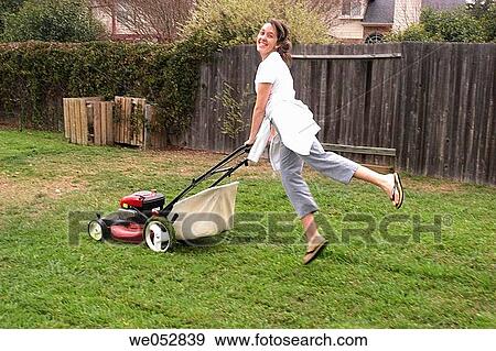 Woman playing while mowing View Large Photo Image Stock Photo - Woman playing while mowing. Fotosearch