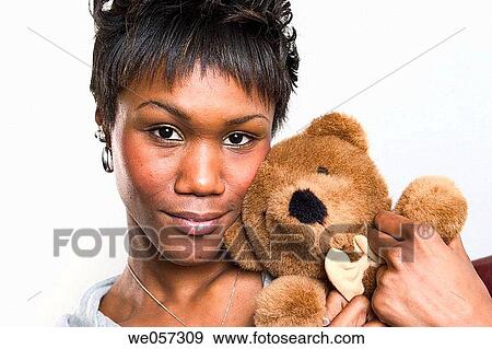 Young black woman posing with a teddy bear View Large Photo Image Stock Photo - Young black woman posing with a teddy bear. Fotosearch