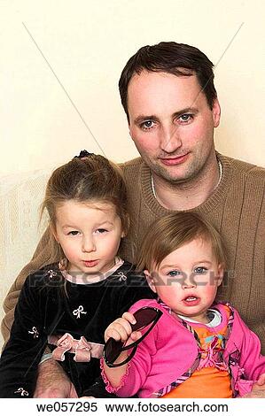 Young girls and their father View Large Photo Image Stock Photography - Young girls and their father. Fotosearch