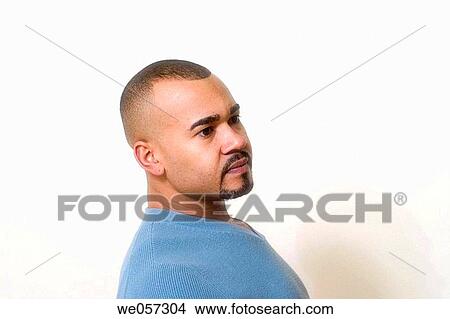 Picture - Young Hispanic man, with a mustache and beard, posing. Fotosearch