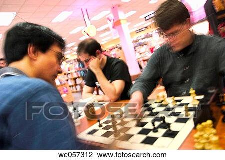 Young men, two of them wearing glasses, playing chess View Large Photo Image Stock Image - Young men, two of them wearing glasses, playing chess. Fotosearch