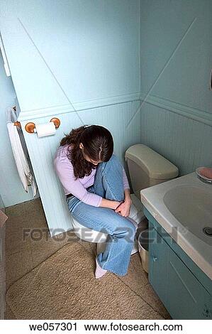 Young woman sitting in her bathroom View Large Photo Image Stock Image - Young woman sitting in her bathroom. Fotosearch