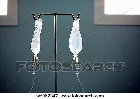 2 IV bags hanging on stand View Large Photo Image Stock Photo - 2 IV bags hanging on stand. Fotosearch