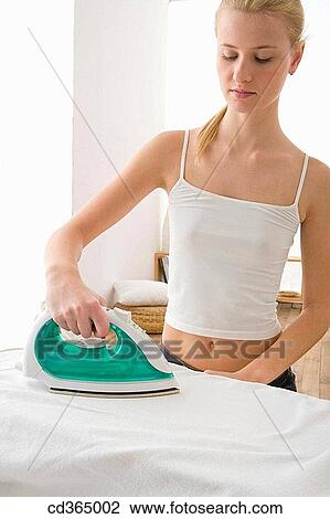 Stock Image - 30's, blond, at-home, appliance, 20's. Fotosearch