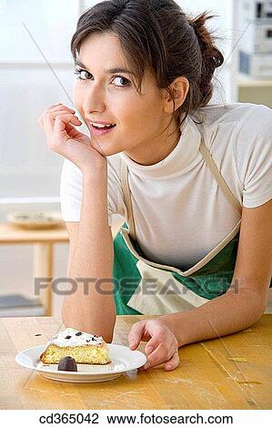 Stock Image - 30's, brunette, at-home, apron, 20's. Fotosearch