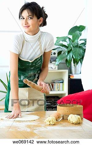 Stock Image - 30's, brunette, at-home, apron, 20's. Fotosearch