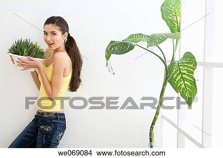 Picture - 30's, carry, brunette, at-home, 20's. Fotosearch