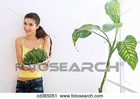 Stock Image - 30's, carry, brunette, at-home, 20's. Fotosearch