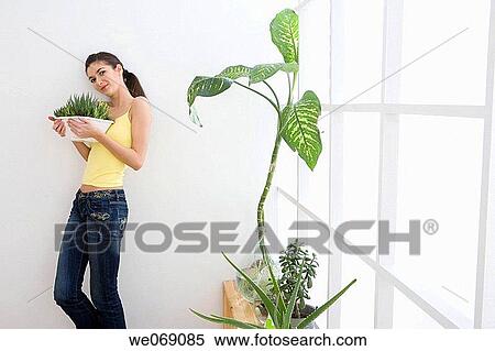 Stock Photography - 30's, carry, brunette, at-home, 20's. Fotosearch