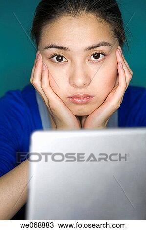 Stock Image - Absent-minded, Asian, absorbed, absent-mindedness, 20's. Fotosearch