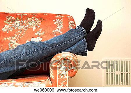 Abstract shot of person's legs crossed while relaxing on a sofa. View Large Photo Image Stock Photograph - Abstract shot of person's legs crossed while relaxing on a sofa.. Fotosearch