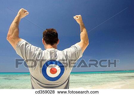 Stock Photo - aim, beach, back view, Arms raised, achievement. Fotosearch