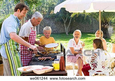 Picture - amusement, barbecue, apron, 3 generations. Fotosearch