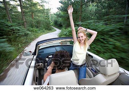 Stock Image - amusement, blurred motion, automobile, Arms raised, 20's. Fotosearch
