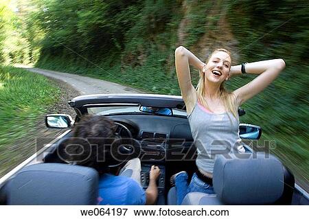 Stock Photo - amusement, blurred motion, automobile, Arms raised, 20's. Fotosearch