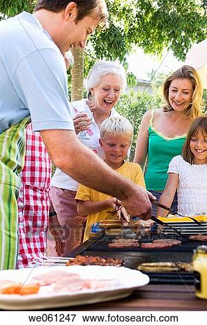 Stock Photo - anticipation, barbecue, apron, 3 generations. Fotosearch