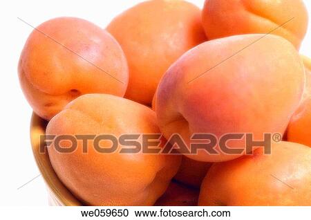 Stock Image - Apricots in a bowl. Prunus armeniaca. July 2006, Maryland, USA. Fotosearch