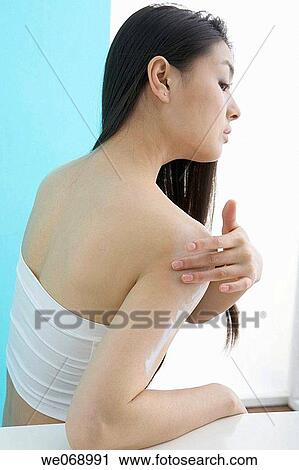 Stock Image - arm, beauty, back view, Asian, apply. Fotosearch