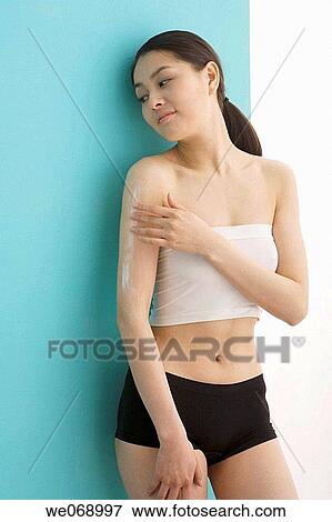 Stock Photo - arm, Body care, Asian, apply. Fotosearch