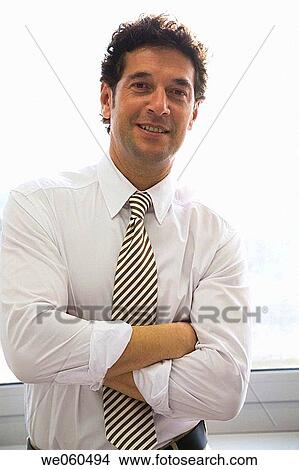 Picture - arms folded, business, black hair, backlight, Arms crossed. Fotosearch