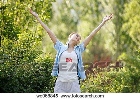 Arms raised, contemporary, Asian, Arms open View Large Photo Image Stock Photography - Arms raised, contemporary, Asian, Arms open. Fotosearch