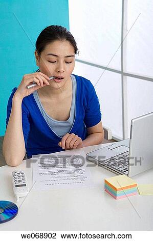 Stock Image - Asian, biting, bite, Ball-point pen, 20's. Fotosearch