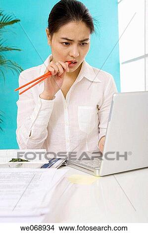 Asian, business, biting, bite, 20's View Large Photo Image Picture - Asian, business, biting, bite, 20's. Fotosearch