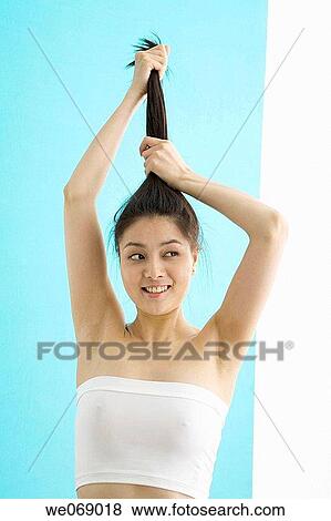 Stock Photo - Asian, carnality, Arms raised. Fotosearch