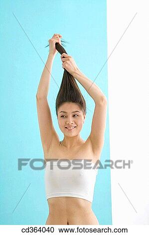 Stock Image - Asian, Chinese, carnality, Arms raised. Fotosearch