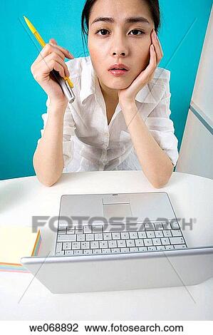 Stock Image - Asian, computer, Ball-point pen, 20's. Fotosearch