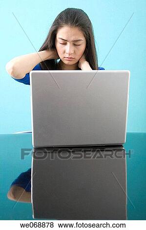 Stock Photo - Asian, contemporary, computer, 20's. Fotosearch