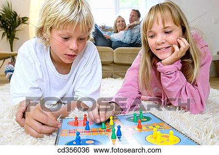 Stock Photograph - at-home, boy, Board game, amusement. Fotosearch