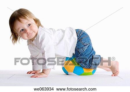 Picture - baby, barefoot, ball, balance, amusement. Fotosearch