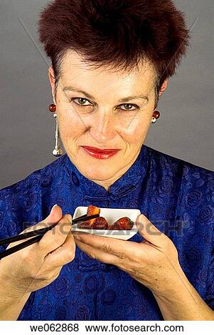 Stock Photo - baby boomer, brunette, chopstick. Fotosearch