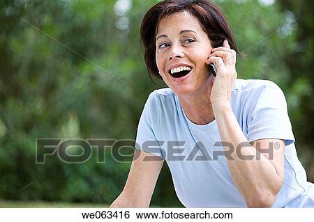 Stock Photograph - baby boomer, calling, cell phone. Fotosearch