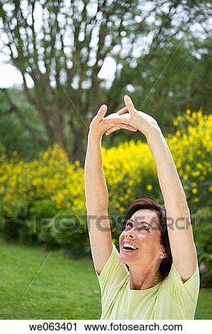 Stock Image - baby boomer, carefree, Arms raised. Fotosearch