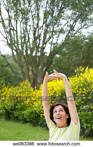 Stock Photograph - baby boomer, carefree, Arms raised. Fotosearch