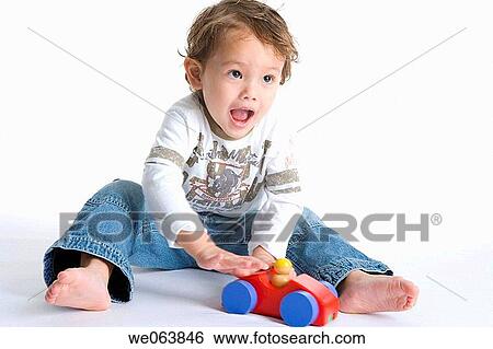 Stock Photograph - baby, boy, black hair, barefoot, 3-4 years. Fotosearch