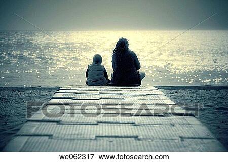 Stock Photo - back view, beach, boardwalk, calm. Fotosearch